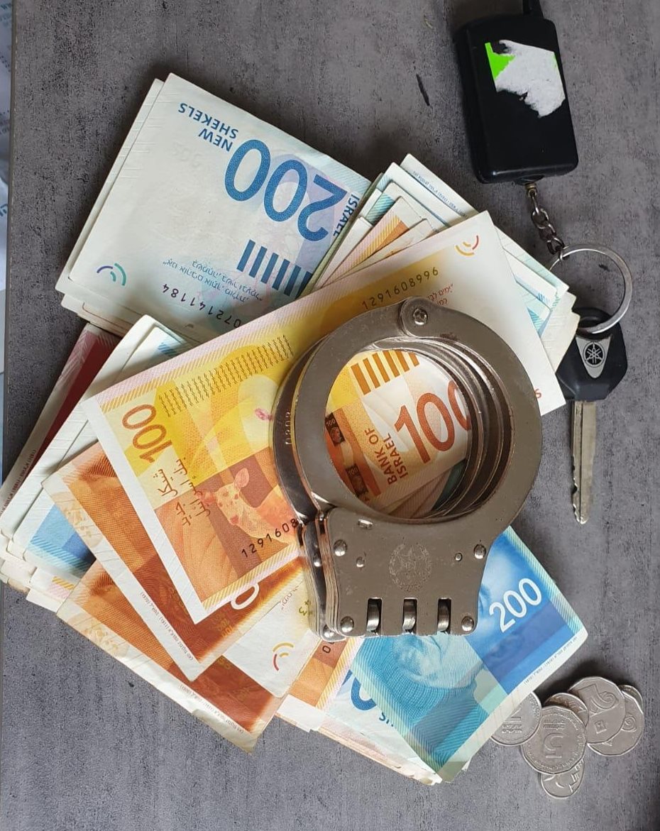 אזיקים משטרתיים וכסף שנמצאו בבית החשוד | צילום: דוברות המשטרה